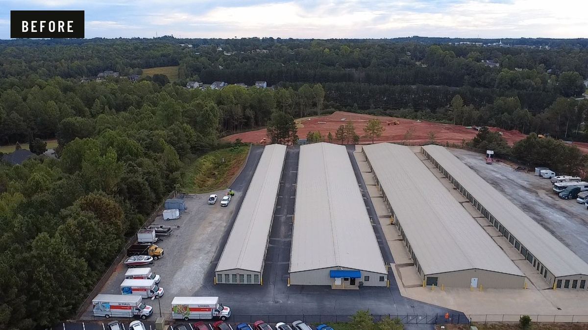 Before: aerial view of a self-storage facility with bare gravel and dirt drive lanes between the buildings.